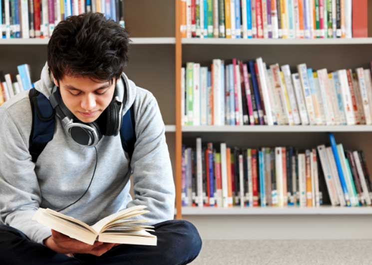 Student in library reading